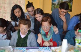 Un grupo de estudiantes juega lota con adultos mayores de la Villa La Primavera, de La Pintana.